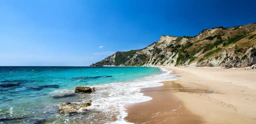 beautiful sandy beach with rock cliffs at southern corfu, Kavos