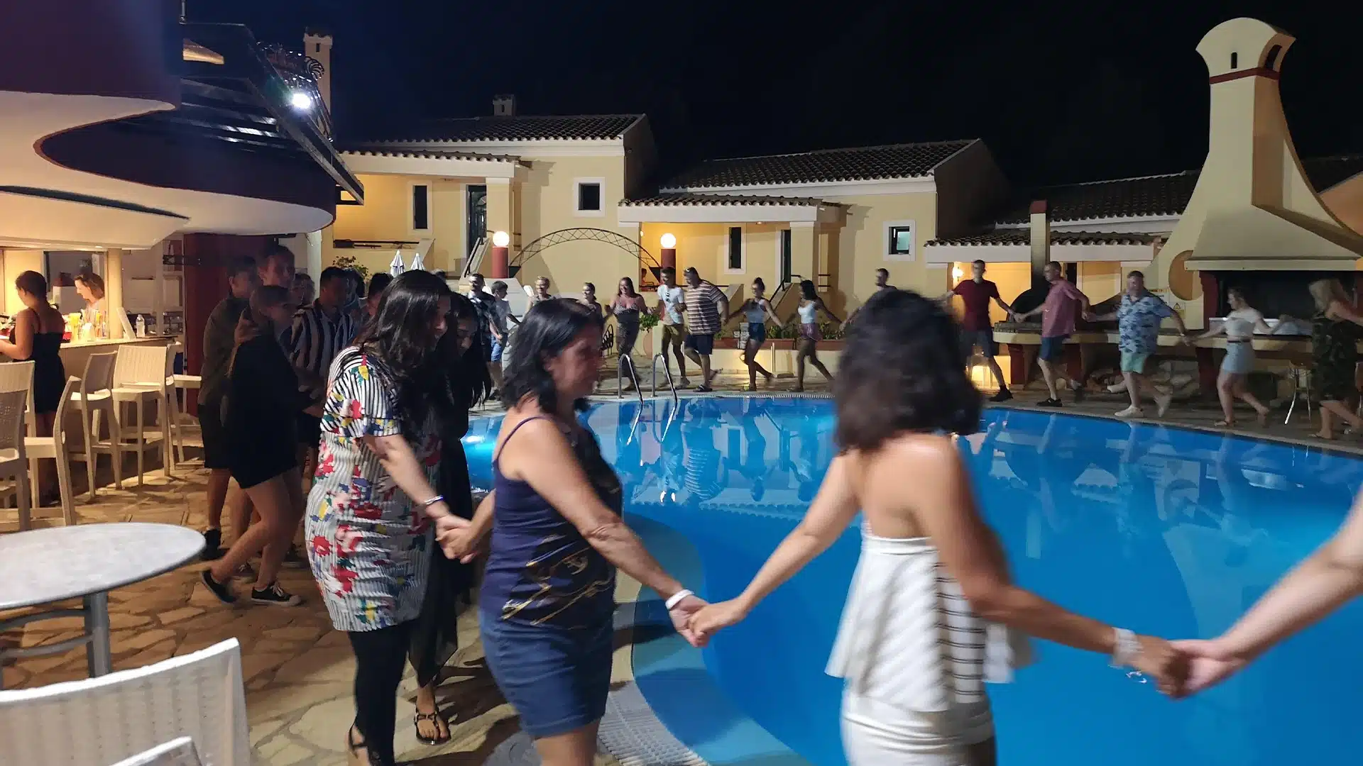 people holding hands while dancing traditional greek dance